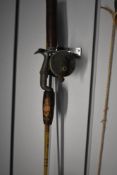 A vintage spinning reel by A.B.URFABRIKEN SVANGSTA, RECORD 1300 made in sweden attached to a small 2