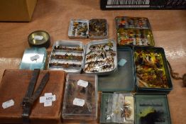 A good selection of salmon and trout flies in an assortment of boxes and tins