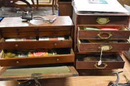 A wooden tool chest and a set of small draws packed with fly making tools and equipment