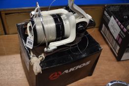 An AKIOS Scora 100 fixed spool reel boxed with spare spool