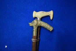 Two walking sticks one with a brass handle moulded with fox or dog mask and concealing a glass