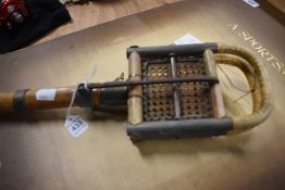 A vintage shooting stick with bamboo shaft and woven seat
