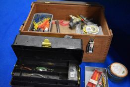 A wooden clip top box containing a selection of sea fishing tackle including lures hooks and