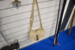 A canvas fishing bag containing a leather fly wallet with casts, a box of salmon flies 2 spring