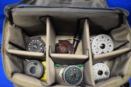 A compartmented snowbee fishing bag containing 5 fly reels and spare spools including rimfly