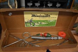A boxed vintage 'Minicaster' coiled spring fishing rod original box