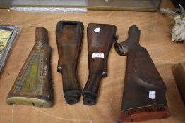Four vintage gun or rifel stocks
