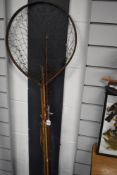 A vintage unmarked fly rod with spare tip a landing net and some split cane rod pieces