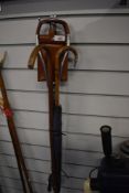 An engraved walking stick, A parasol with silver metal mount on the handle and a leather seated