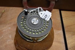 An Orvis C.F.O V fly reel in a suede case