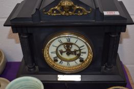 A Victorian slate mantel clock with visible procut escapement and gilt decoration. Case having