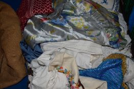 A miscellany of vintage items and accessories, including evening scarves, children's wear, apron and