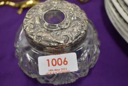 A white metal topped cut-glass hair tidy, lacking marks and denting and wear throughout.