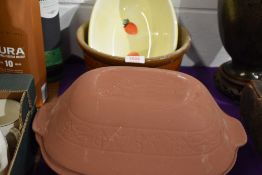 An early 20th century cream bowl with a terracotta cooking pot and similar.