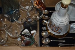 A blue tinted glass water jug, eight champagne glasses, an empty Wade Bells Scotch Whiskey bell, a