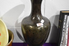A Japanese Cloisonne enamel vase having black ground, with yellow metal wire. On carved wooden base.