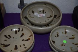 A set of six matching studio pottery bowls having natural glazes.