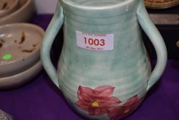An Art Deco Emily Radford three handled vase hand painted with floral scene.
