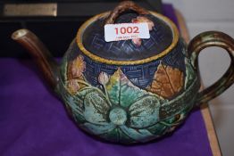 A Victorian Majolica tea pot having lozenge registration stamp to base, damage and repair to
