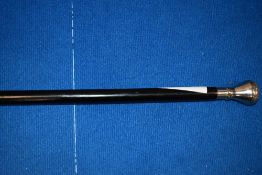 A vintage walking cane having white metal knop.