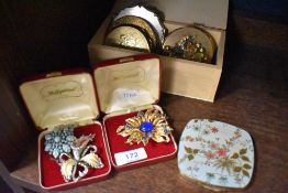 Six mid century make up compacts including Zenette with a selection of large brooches.