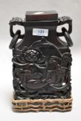 A 19th century Chinese Bird and Flower decorated vase on wooden carved stand. Possibly made from