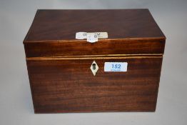 A Georgian tea caddy of plain form with mahogany case lion head handles and inlayed detail.