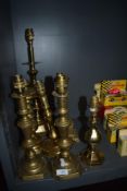 A good selection of early 20th century and later brass lamp bases including converted candlesticks