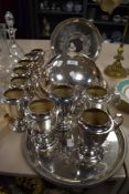 Ten vintage Art Deco silver plated mugs with a domed cloche and five silver plated trays.