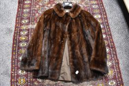 A vintage mid length ladies dark fur coat.