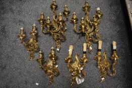 Three 5 branch and two 2 branch wall mounted heavy cast brass lights having classical scroll work