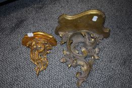 A Victorian carved wood wall sconce with a similar pottery wall sconce.