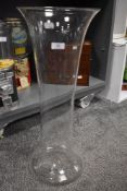 A modern large floor standing hand blown glass vase of fluted bell form 60cm tall.