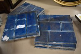 A set of nine early 20th century wall tiles having a deep blue glaze.