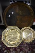 An antique Indian brass table top tray with two similar brass trays.