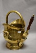 An early 20th century coal bucket with matching brass coal shovel.