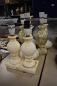 Two vintage onyx stone cut lamp bases with five white alabaster lamps.