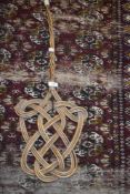 An antique wicker carpet beater.