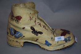 A vintage terracotta garden shoe hand painted with insects.