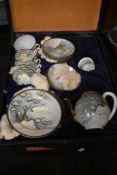 An early 20th century cased Chinese porcelain tea set decorated with birds and foliage.