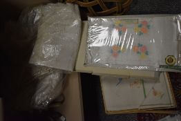A selection of vintage linen including table mats, embroidery and lace work.