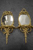 A pair of late Georgian wall sconce and mirrors, having gilt and gesso frames with scrolled ribbon