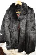A vintage full length ladies dark fur coat.