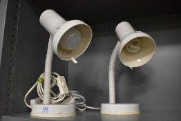 A pair of modern goose neck side lamps.