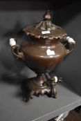A Victorian samovar tea urn having a copper body with ceramic handles and shell form decoration.