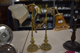 a pair of unmatched library lamps having brass cast bases