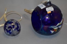 A modern art glass hanging basket with a similar hand blown ball.