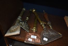 Five Victorian carpet cleaners in brass and copper.