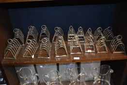 A shelf of Art Deco silver plated toast racks ideal for bed and breakfast.