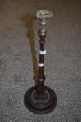 An early 20th century turned mahogany candlestick